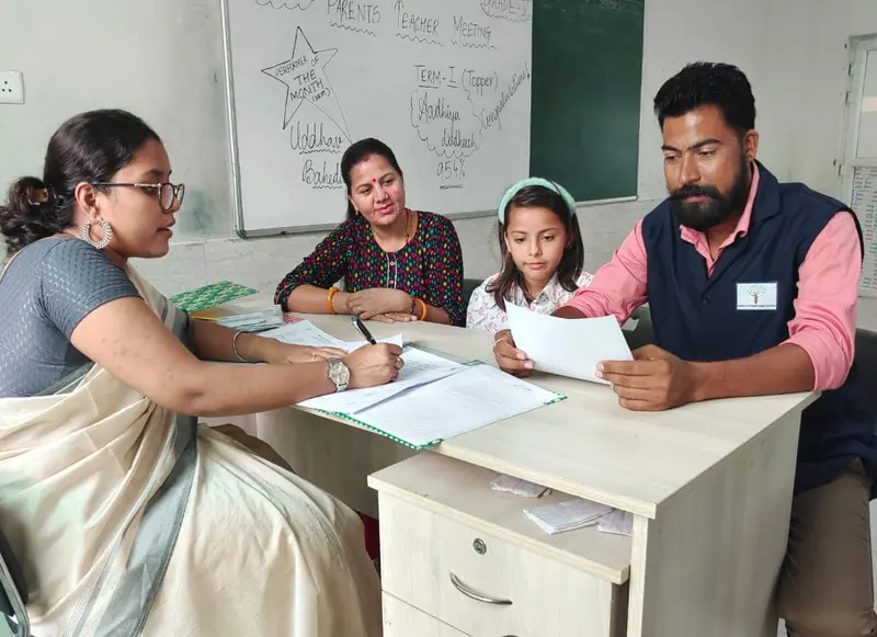 Parents and a student meeting a teacher