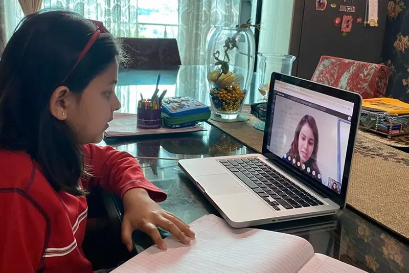 A student following a class on a laptop at home